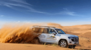 Arabian Heritage desert safari tour, Dubai SUV driving through golden sand dunes during an adventure dune bashing experience