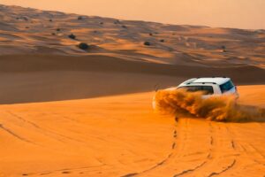 What is dune bashing in Dubai SUV driving on golden sand dunes