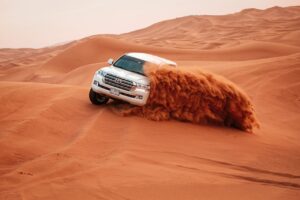 Dune bashing in Dubai, tourists enjoyinga desert ride